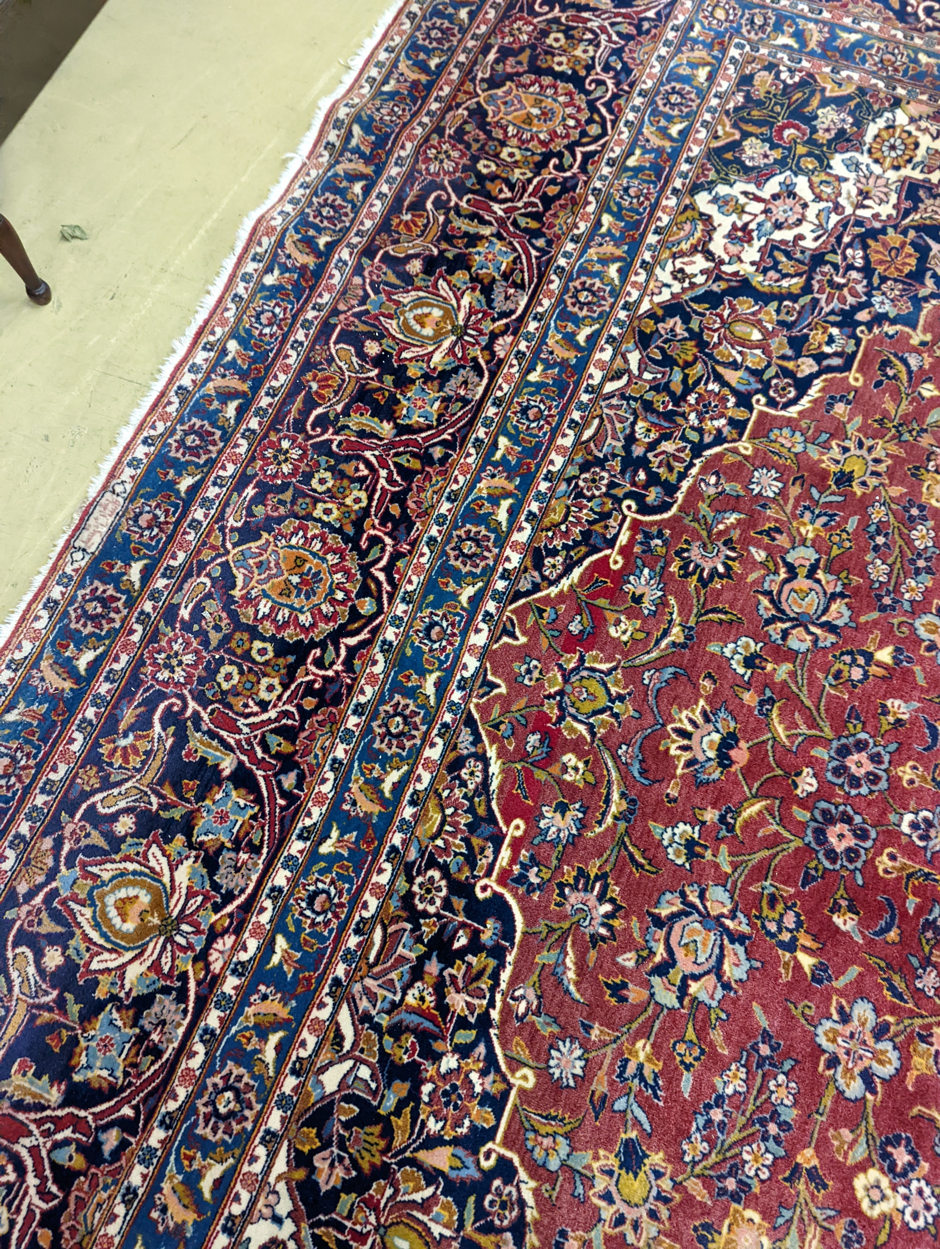 A large Tabriz red ground floral carpet, 540 x 350cm